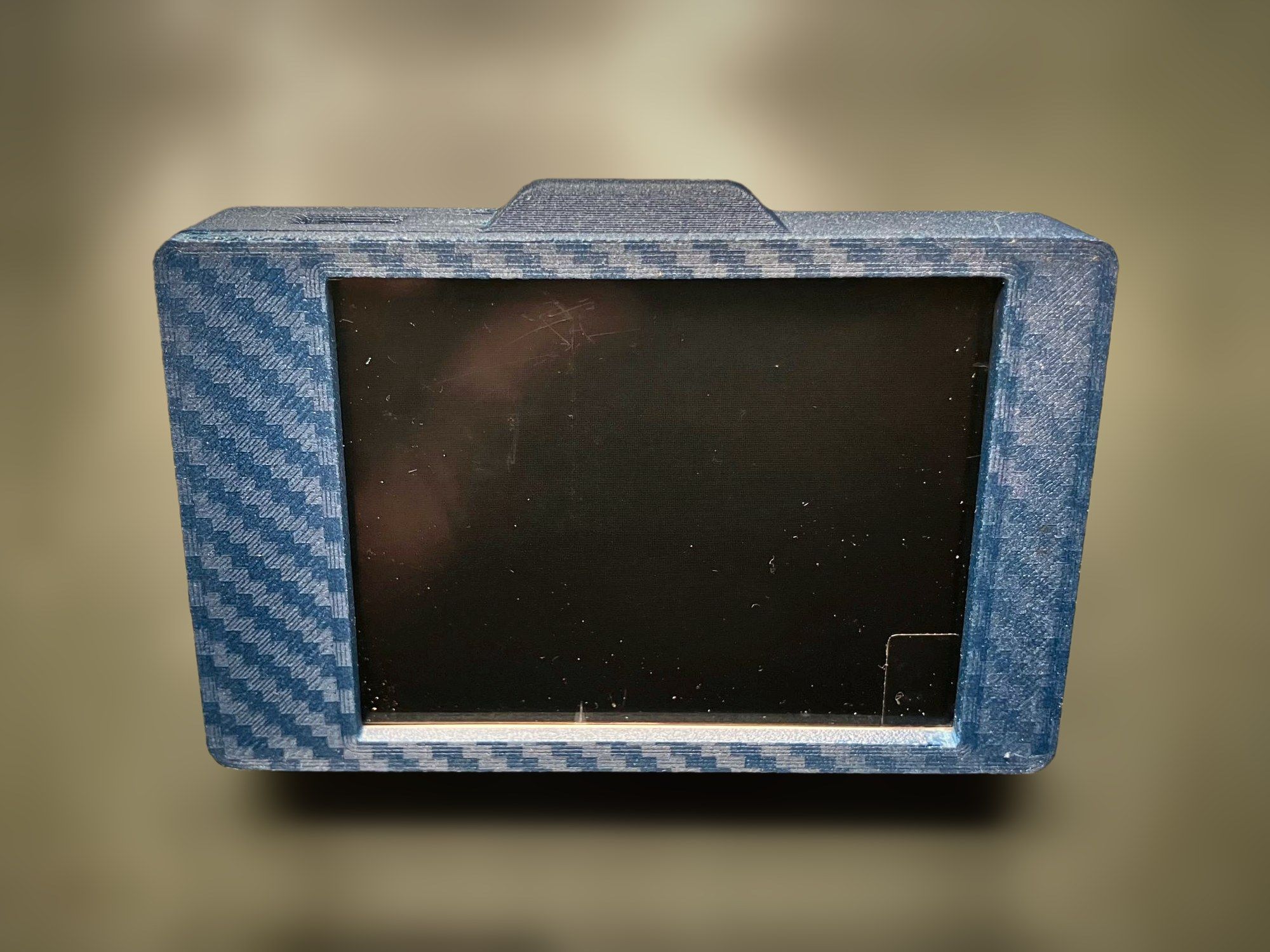 Sentinel v1.4 prototype main unit in a blue carbon-pattern enclosure, seen from the front at an angle